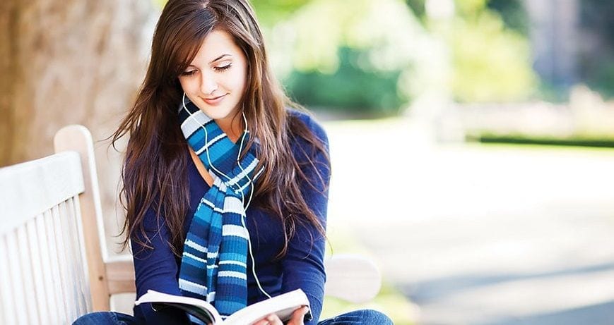 A student reading in the campus park